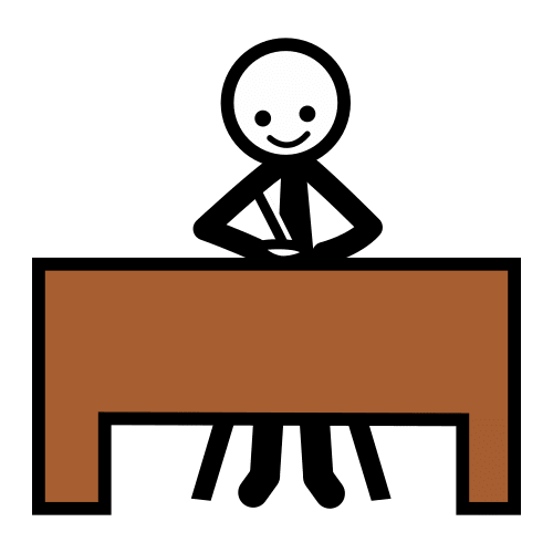 Una persona sentado delante de una mesa sobre la cual trabaja.