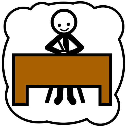 Una persona trabaja solo sentado en una silla delante de una mesa.