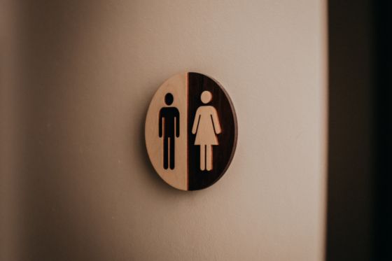 Imagen de la puerta de acceso a un servicio con el simbolo de permitido para hombres y mujeres.