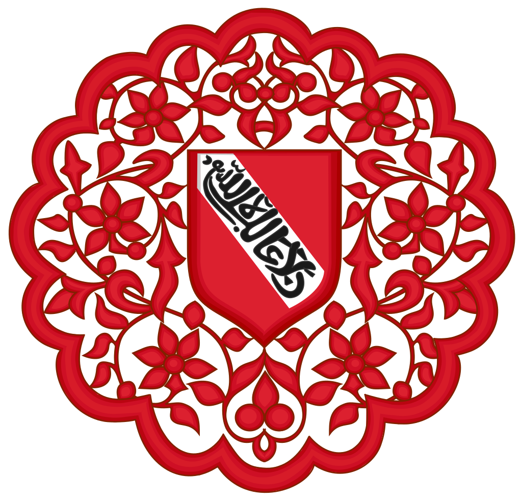 Escudo de forma redonda en color rojo, imitando plantas enroscadas con un escudo en el centro.