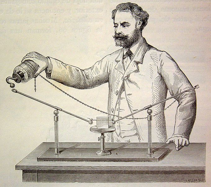 La imagen muestra a un hombre con barba realizando un experimento.