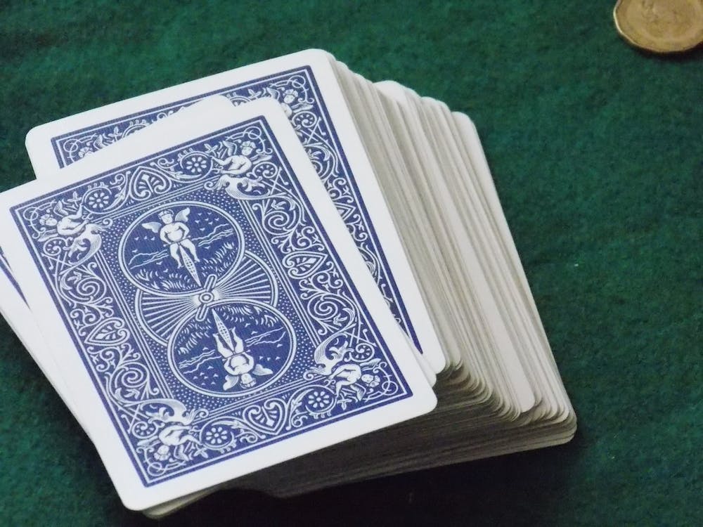 La imagen muestra una baraja de carta colocadas boca abajo de color azul y blancas. 
