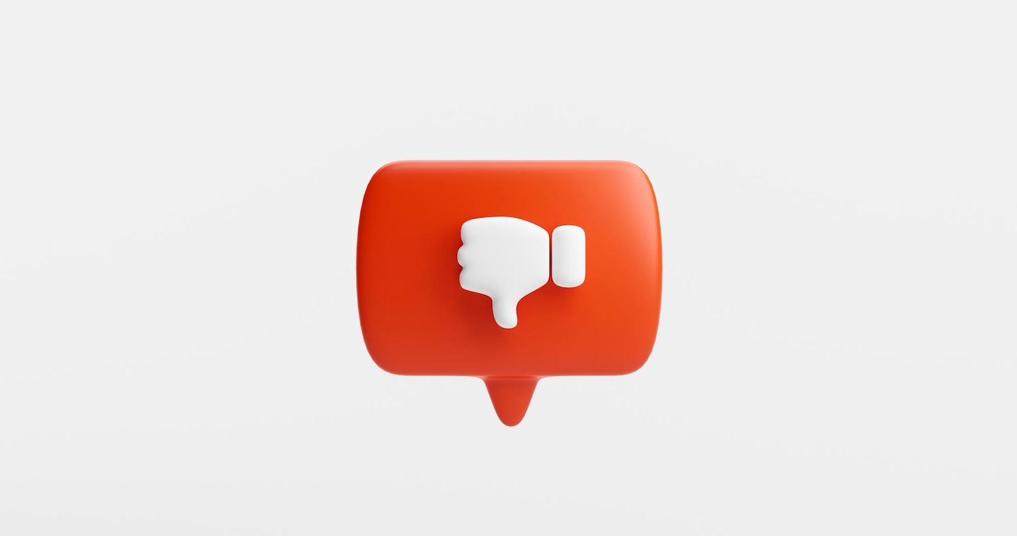 La imagen muestra una burbuja roja como botón o icono con pulgar hacia abajo como concepto de no gustar.