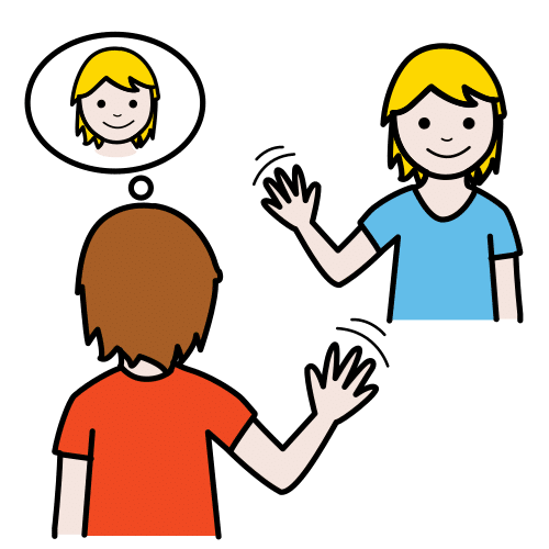 Una niña levanta la mano desde su pupitre para responder.