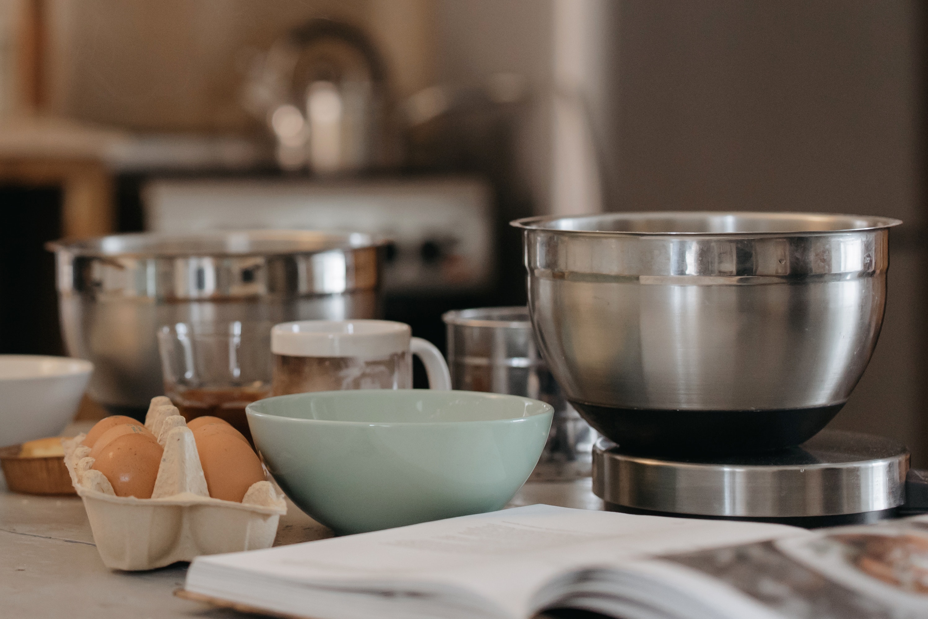 Esta imagen muestra distinto menaje de cocina sobre una encimera y una huevera.
