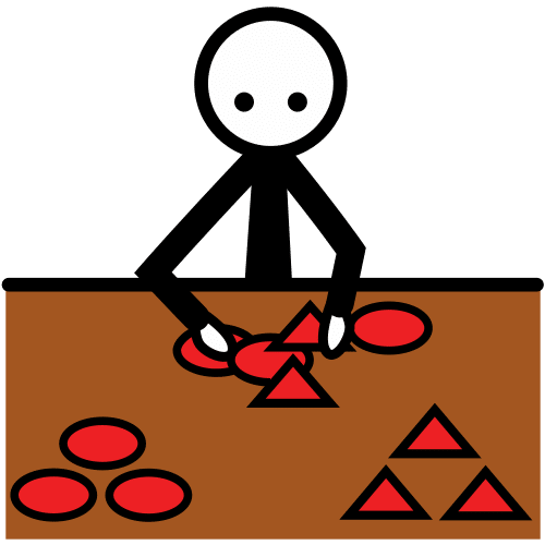 La imagen muestra a una persona clasificando en dos grupos, en una mesa, triángulos y círculos.