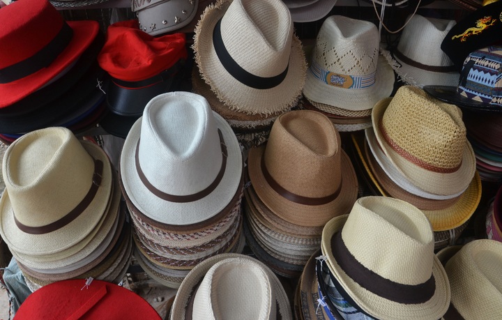 La imagen muestra diferentes sombreros apilados en una tienda 