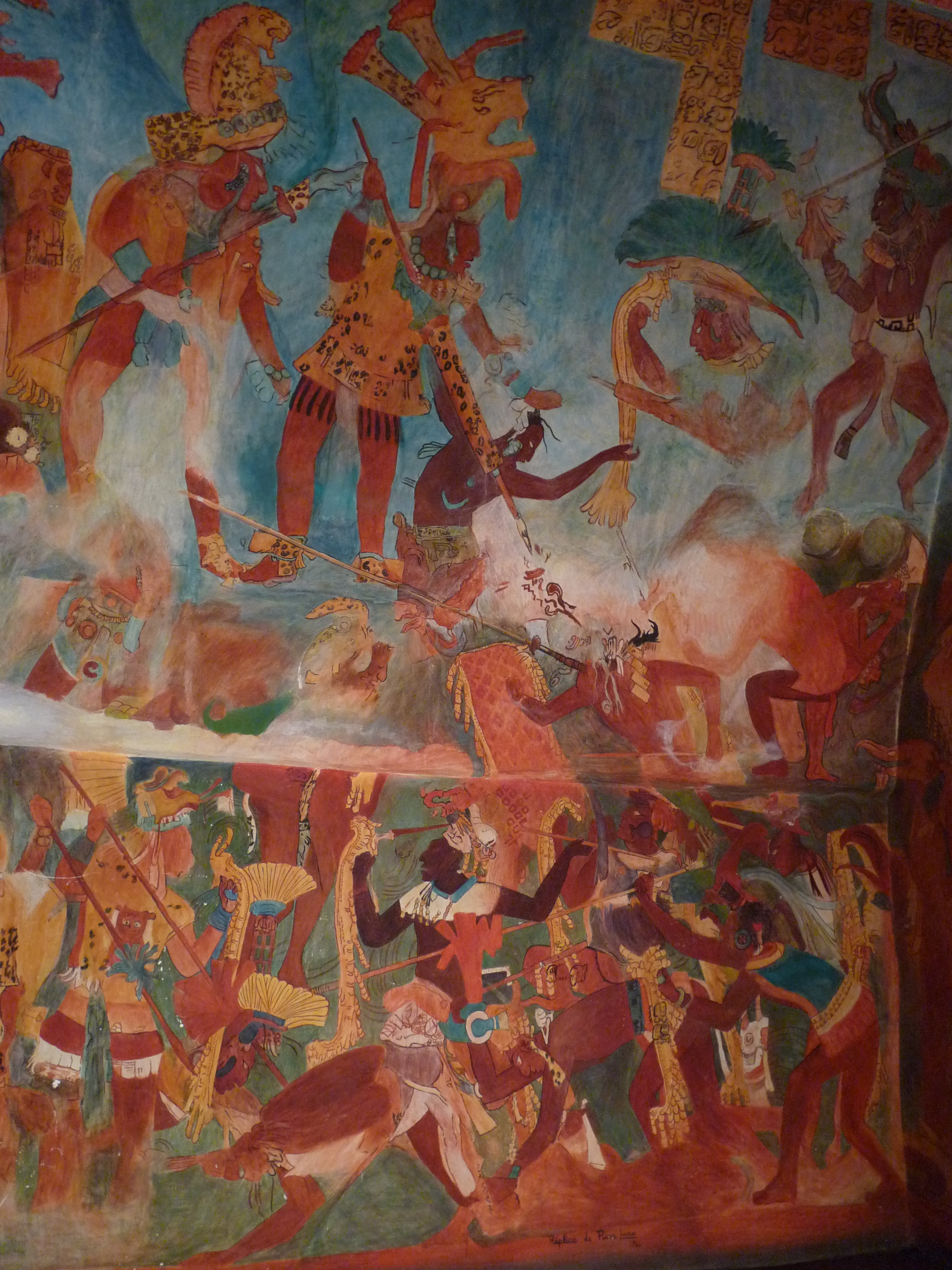 La imagen muestra varios personajes de piel oscura y vestimentas tradicionales con escudos y lanzas, que están luchando