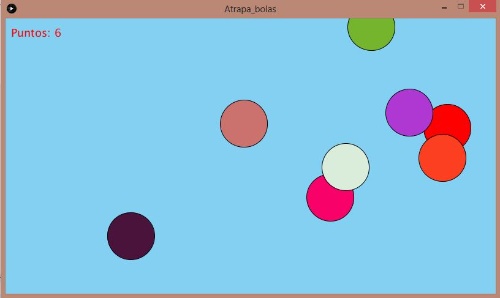 Imagen del juego atrapa la bola roja. Se observan sobre un fondo azul varias bolas de colores.