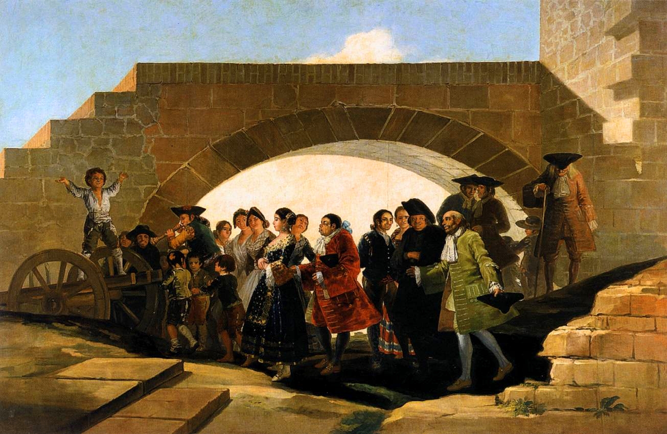 Un grupo de personas celebran una boda bajo un puente.