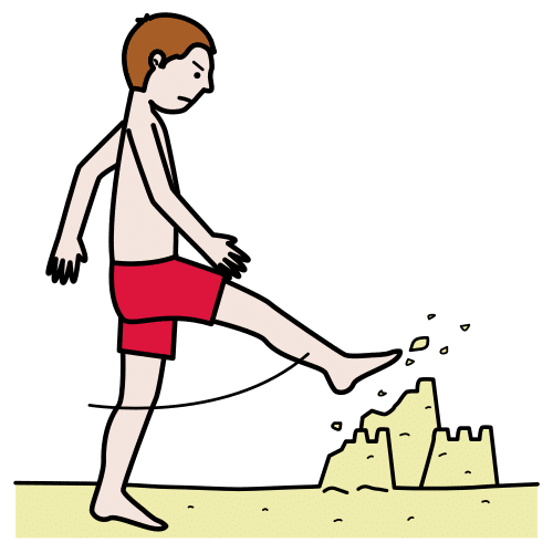 Persona en la playa pisando un castillo de arena